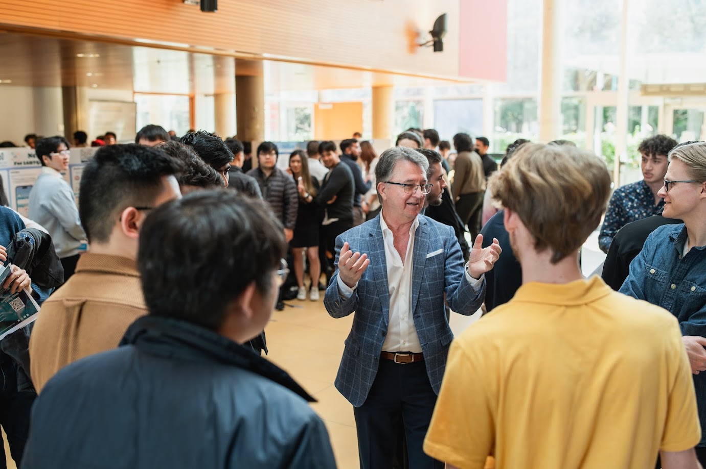 a man talking to a group of students.