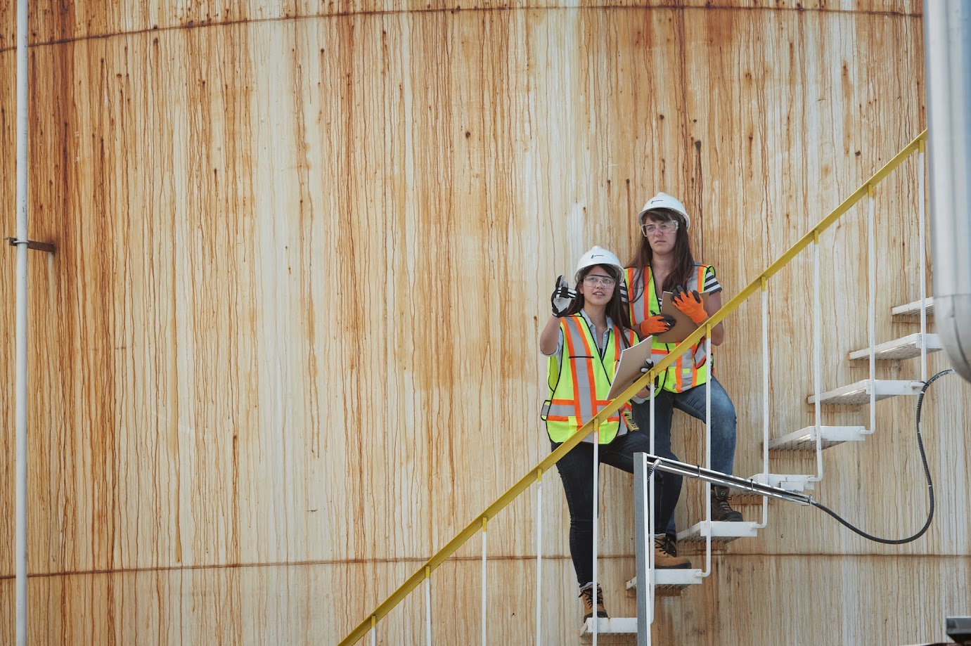 2 women on the stairs of a construction site