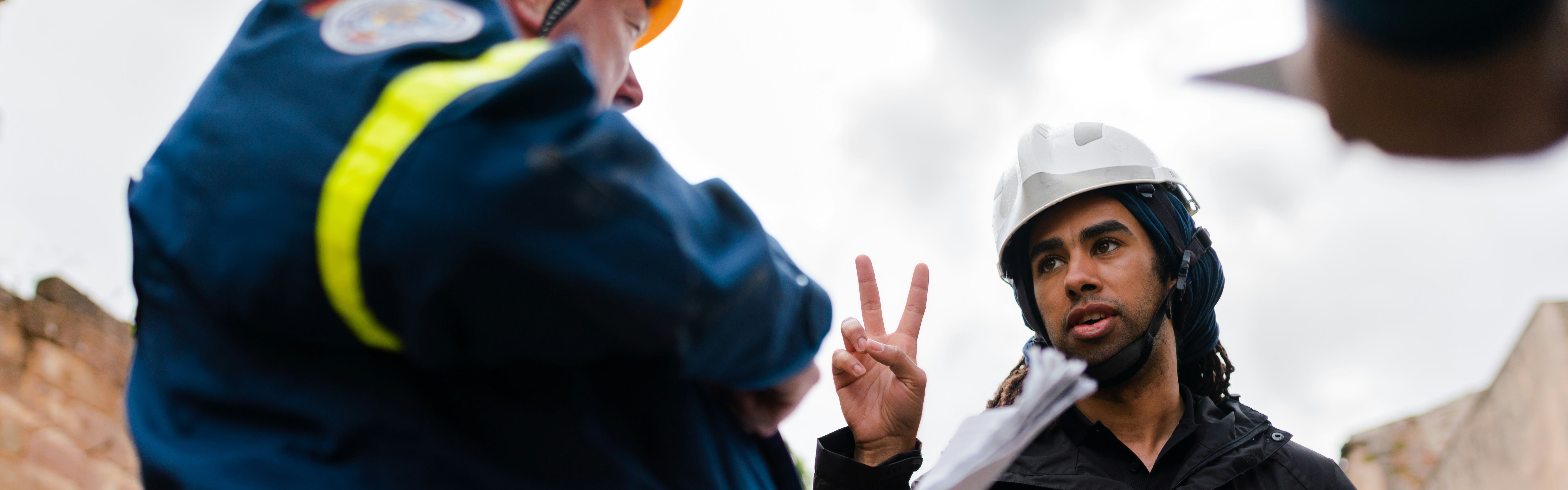 an engineer holding up two fingers