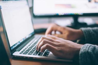 An individual using their laptop, accessing resources 