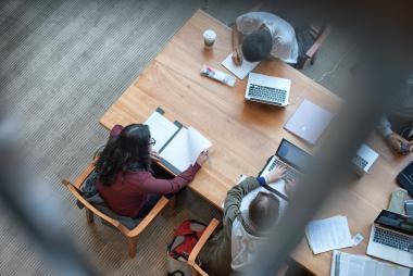 top down shot of four students studying at IKB library