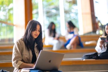 a woman looking down at her laptop.