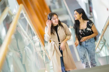 two women talking to each other.