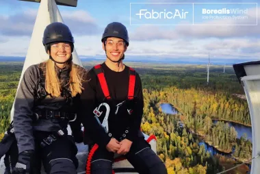UBC APSC alumni Daniela Roeper and Dylan Baxter of Borealis Wind, sitting on top of a wind turbine. 