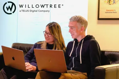 WilloTree, a TELUS Digital Company Stock Image, featuring a WillowTree logo and team members working 