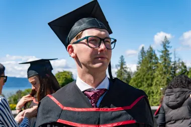 UBC alum Harry Riley posing during graduation 