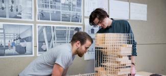 Two students building a model