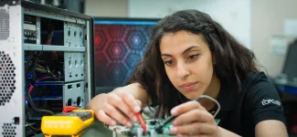 A student working on a circuit board