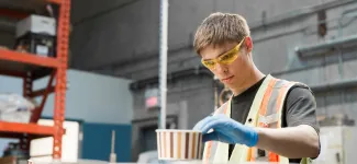 A student working in a warehouse