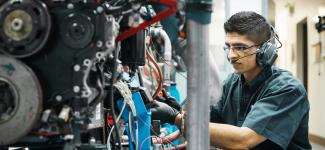 A student fixing a machine