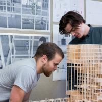 Two students building a model