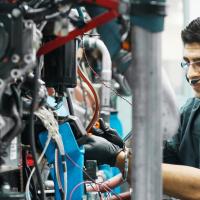 A student fixing a machine